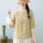 ⁦قميص نسائي صيفي قصير الأكمام بياقة دائرية من القطن والكتان، بتصميم كلاسيكي أنيق وفضفاض، مزين بتطريزات تُخفي علامات التقدم في السن.⁩ - الصورة ⁦12⁩